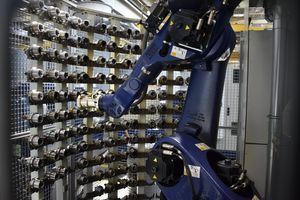 A robotic arm pulling a tool out of its location in the tool magazine