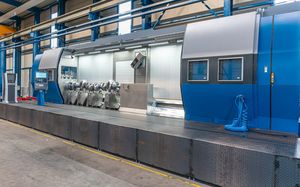 A Weingärtner mpmc - multi product machining center, doors open, from an angular perspective. Inside is a crankshaft