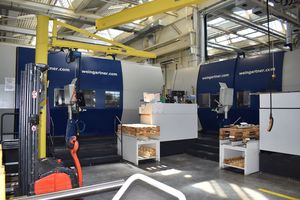 Two milling machines adjacent to each other in a production hall