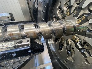 A close up of a whirling disc machining a plasticising screw