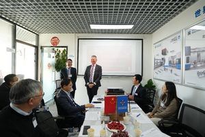 A boardroom with two presenters and a couple of people listening to them