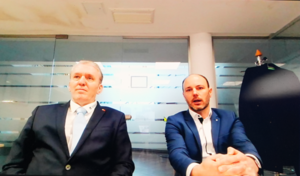 Two men sitting next to each other, captured on webcam